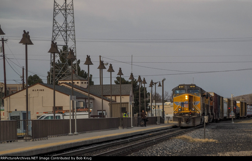 Westbound manifest freight pauses at the Alpine, Texas Amtrak station for a crw change